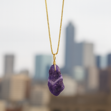 Purple crystal necklace on a blurred cityscape background