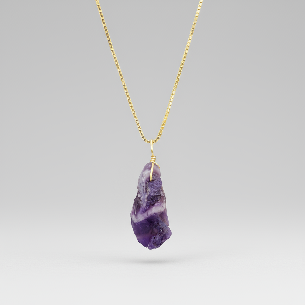 Chevron amethyst pendant on a gold chain against a white background